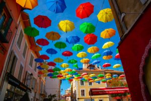 Multicoloured rainbows decorate a street