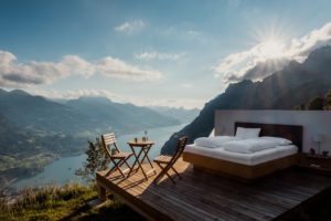 A stunning outdoor luxury hotel room overlooking a Swiss lake